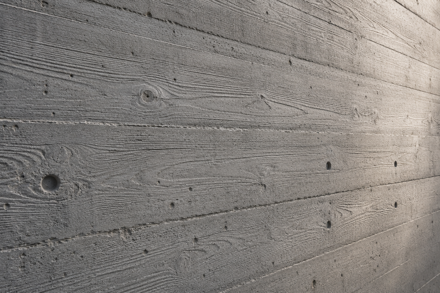 Board-marked concrete finish on a staircase showing timber grain pattern impressed into the concrete surface